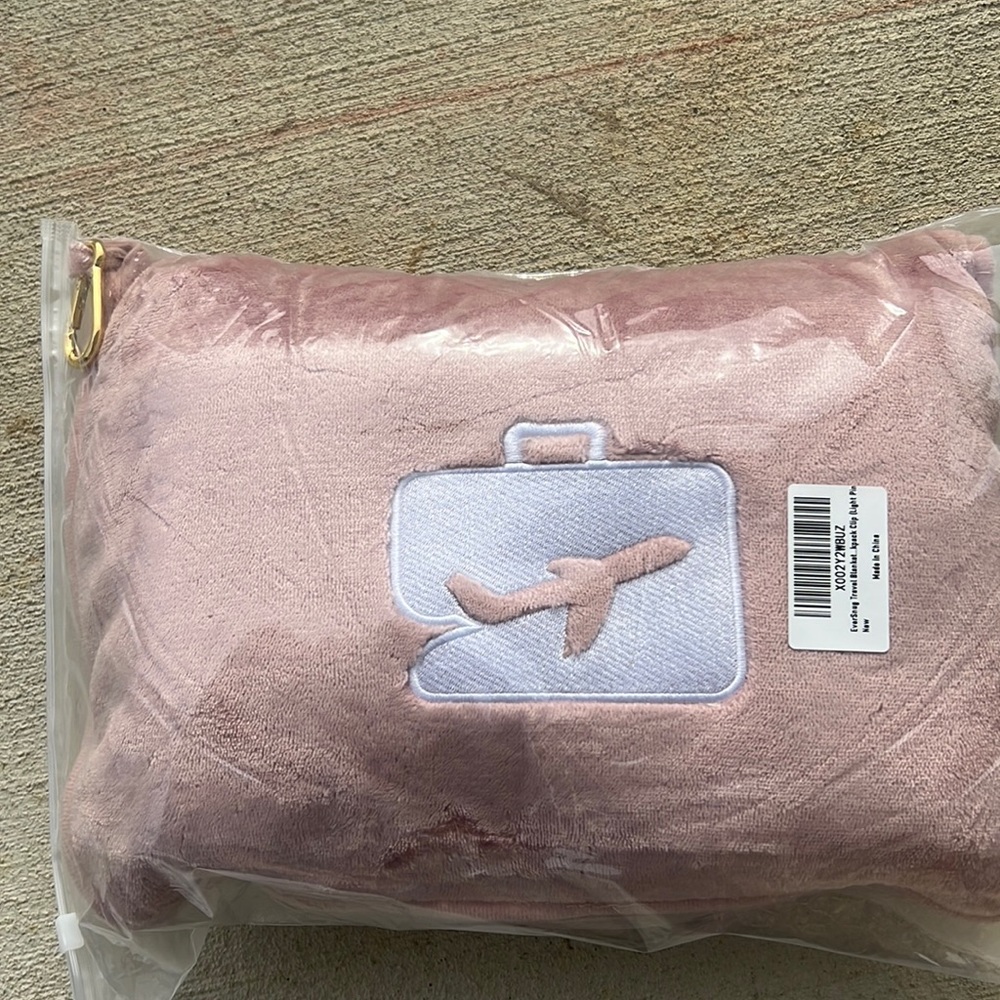 Travel blanket that also duals as a pillow. Perfect for flying never been used
